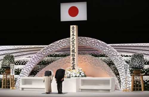 Japan's Emperor Akihito (R) and Empress Michiko bow in front of the altar for the victims of the March 11, 2011 earthquake and tsunami at the national memorial service in Tokyo March 11, 2015. 