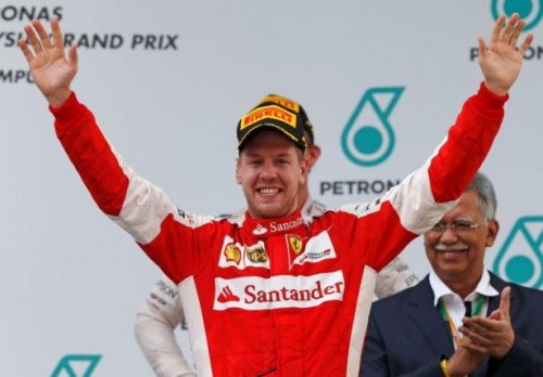 Ferrari's Sebastian Vettel celebrates winning the Malaysian Grand Prix on the podium. Reuters