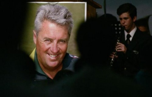  A school boy plays a musical instrument beside a poster of Pakistan cricket coach Bob Woolmer during his memorial service in Cape Town April 4, 2007. 