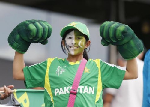 A Pakistani fan shows her muscles before the World Cup match in Auckland. –Reuters