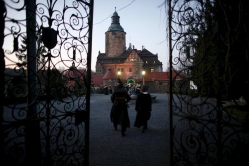 Participants walk as they wait for the beginning of the role play event at Czocha Castle in Sucha, west southern Poland April 9, 2015.