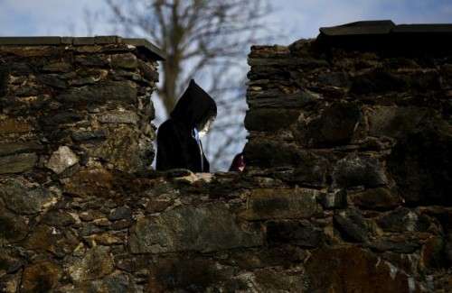 A participant walks near a castle defense wall before the role play event at Czocha Castle in Sucha, west southern Poland April 9, 2015.