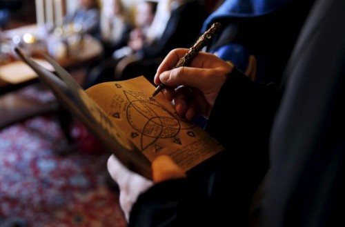 A participant draws on his 'secret book' during a workshop before the role play event at Czocha Castle in Sucha, west southern Poland April 9, 2015
