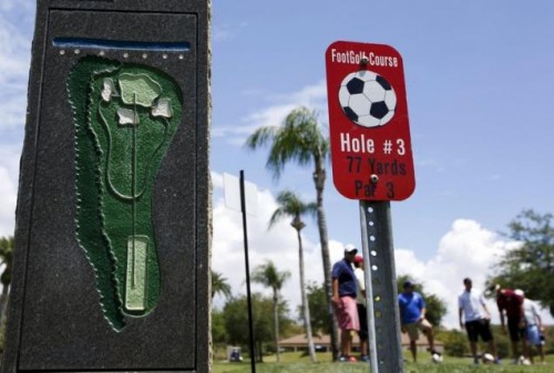 People stand at the FootGolf course at Largo Golf Course, which runs alongside the regular golf course, in Largo, Florida
