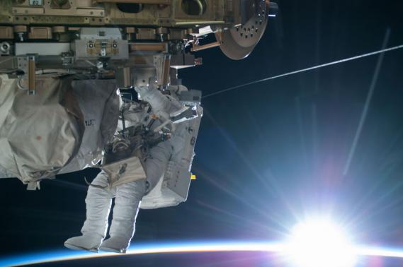 Astronauts breeze through spacewalk to rig station for US space taxis