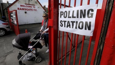 As Britain votes, election polls predict dead heat