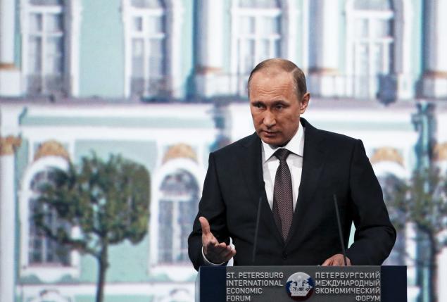 Putin says Russia weathering sanctions, lectures West