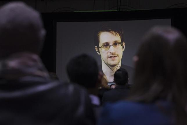 Britain pulls out spies as Russia, China crack Snowden files 