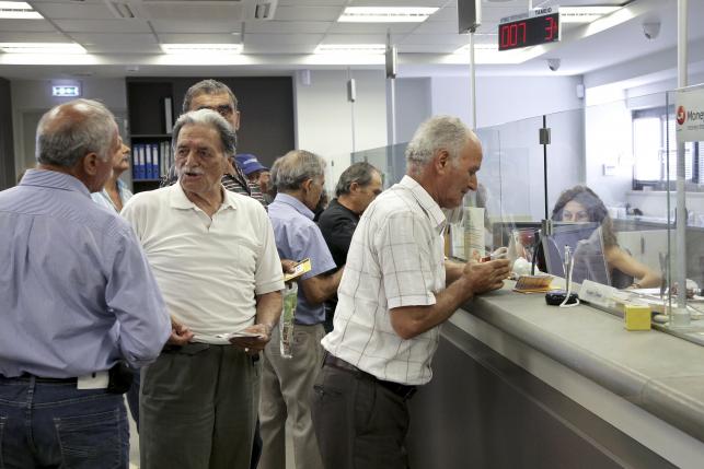 Greece reopens banks, starts repaying some debts