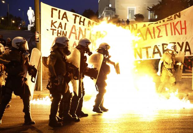 Protesters clash with police before Greek parliament votes on bailout