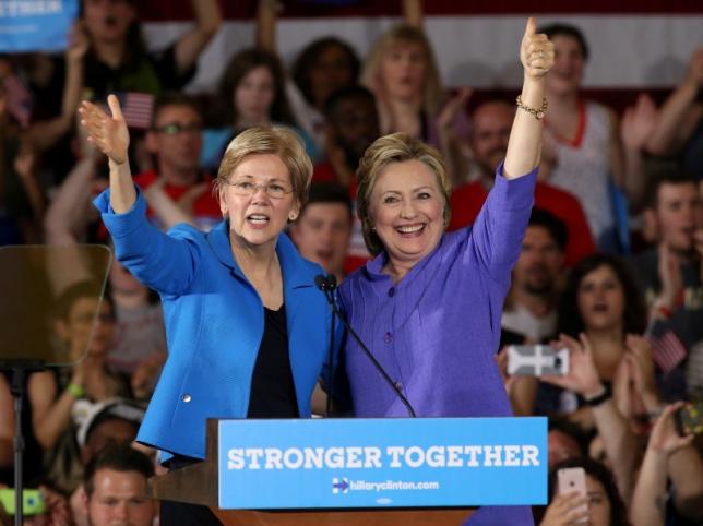 In campaign trail debut with Clinton, Warren says Trump driven by greed