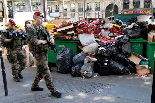 Paris deploys private trash trucks to beat strike as Euro soccer starts