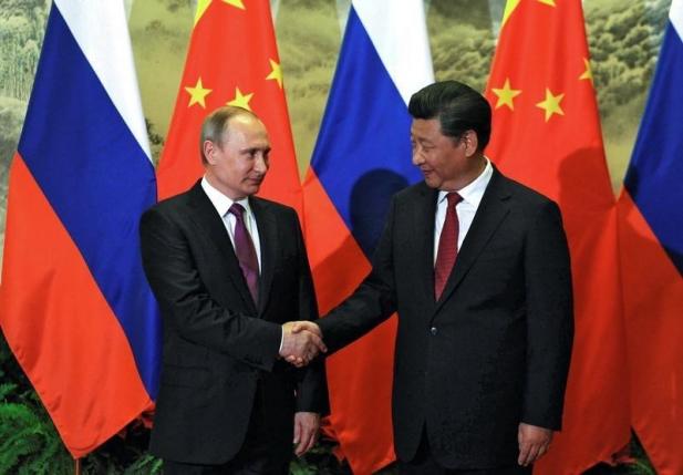 Russia secures energy deals, talks security with China as Putin visits