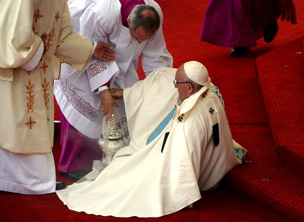 Pope Francis falls over as he arrives for ceremony in Poland