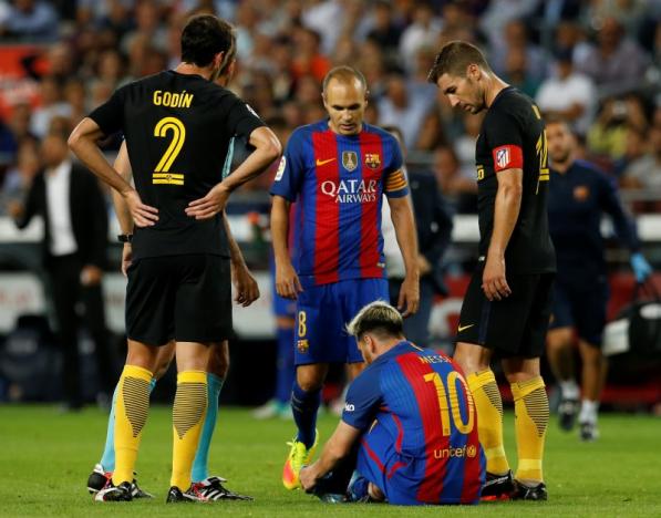 Messi goes off injured as Barca held by Atletico