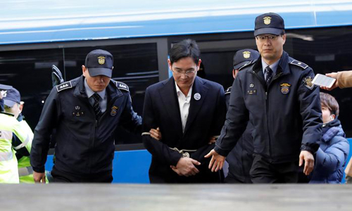After night in cell, Samsung scion taken for questioning