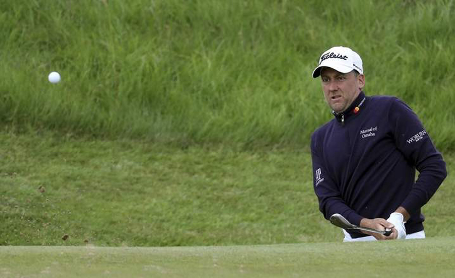 Poulter takes lead after early carnage at British Open