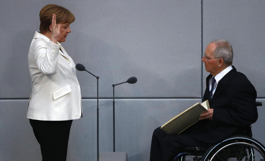 Weakened Merkel begins fourth term beset by challenges