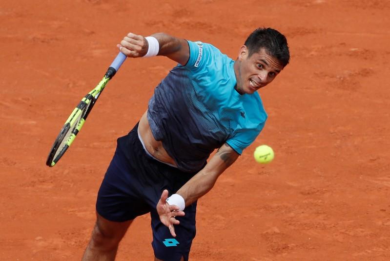 Djokovic's bid for second French Open off to glum-faced start