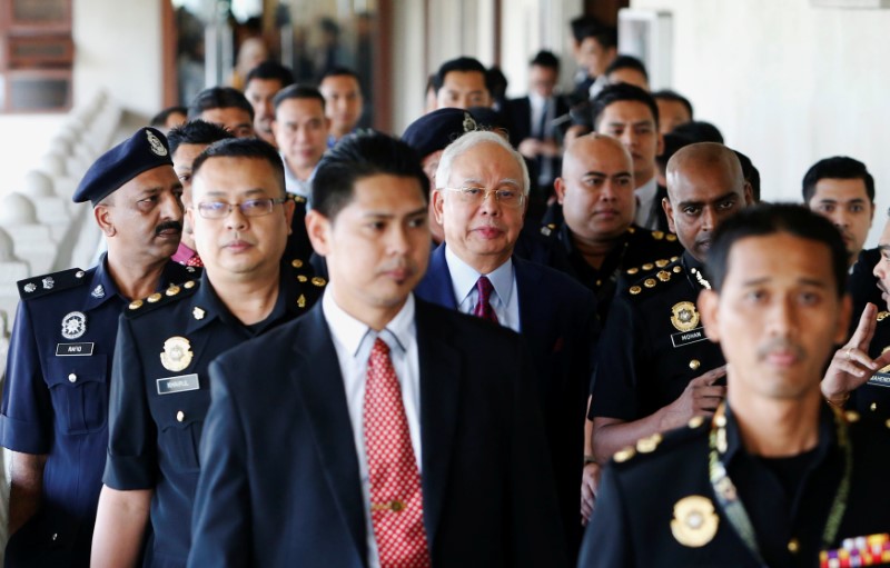Former Malaysian PM pleads not guilty to breach of trust, abuse of power