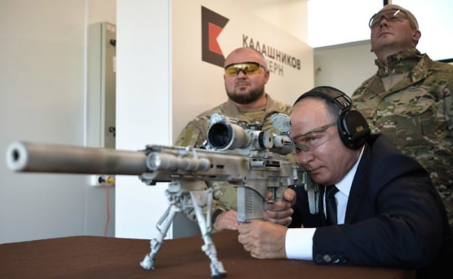 Putin shows off sniper skills firing Kalashnikov rifle