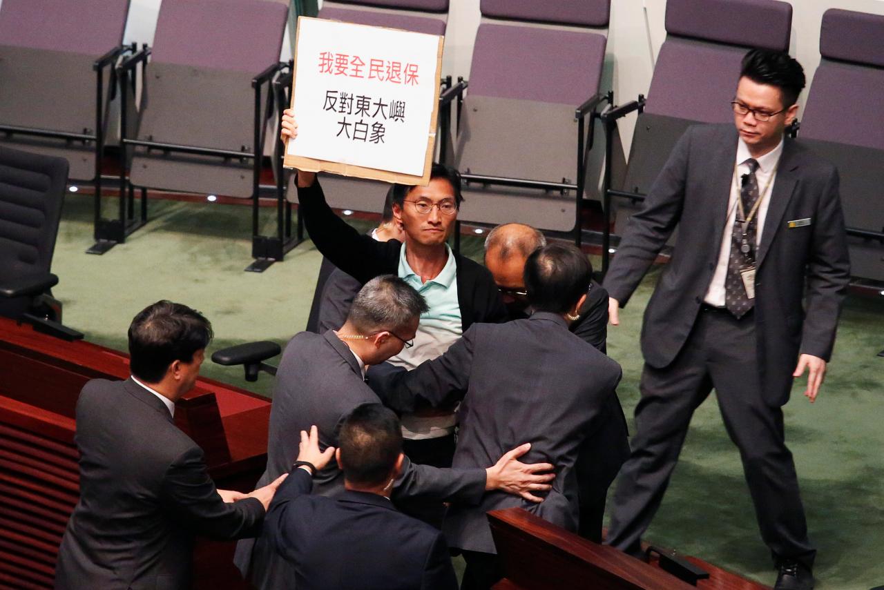 Hong Kong lawmakers walkout over media freedoms at city leader's policy address