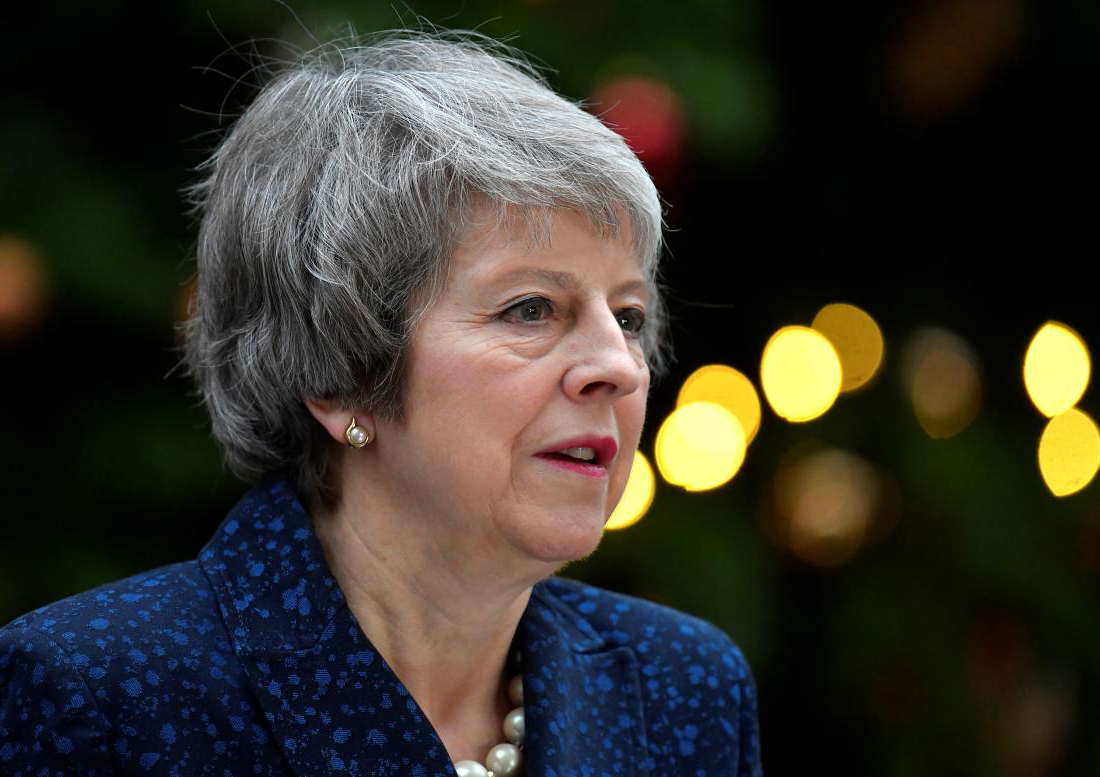 May vows to fight on, warning Brexit is in peril