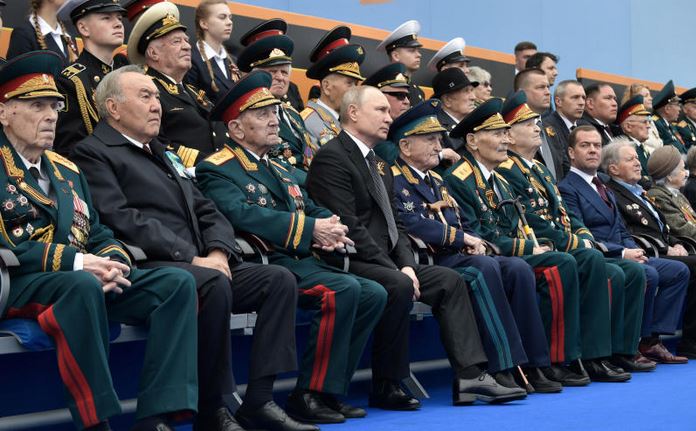 Putin, battling ratings slump, reviews Red Square military parade
