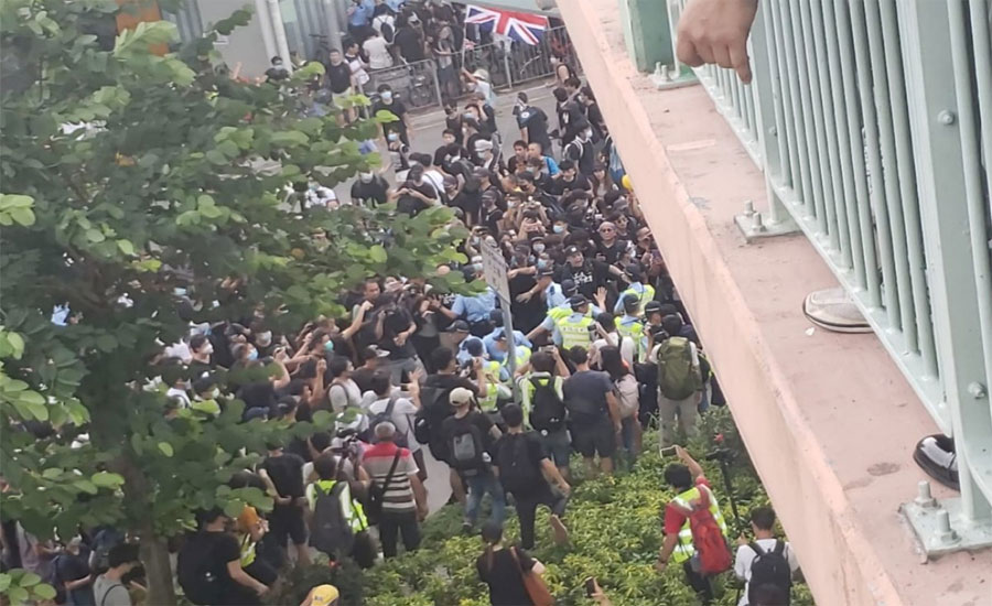 Hong Kong protesters march near border to target traders from China