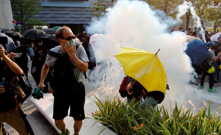 Hong Kong protesters, police in dusk standoff after tear gas breaks up rally