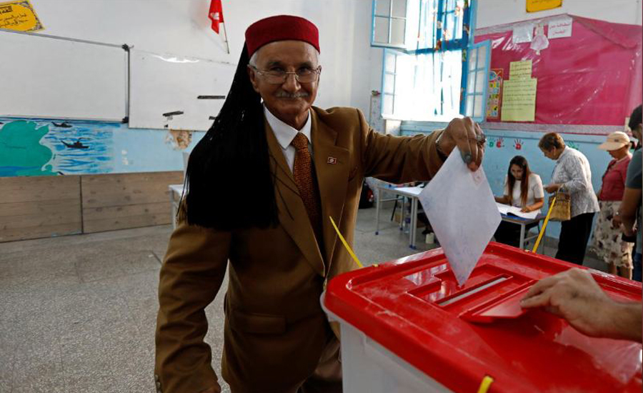 Tunisians vote for new parliament at tough economic moment