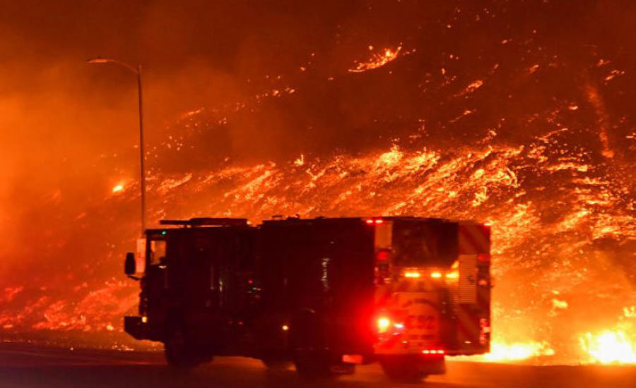 One man dies as wind-driven Los Angeles wildfire forces 100,000 to flee