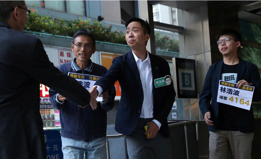 Champagne flows as landslide democratic win puts pressure on Hong Kong leader