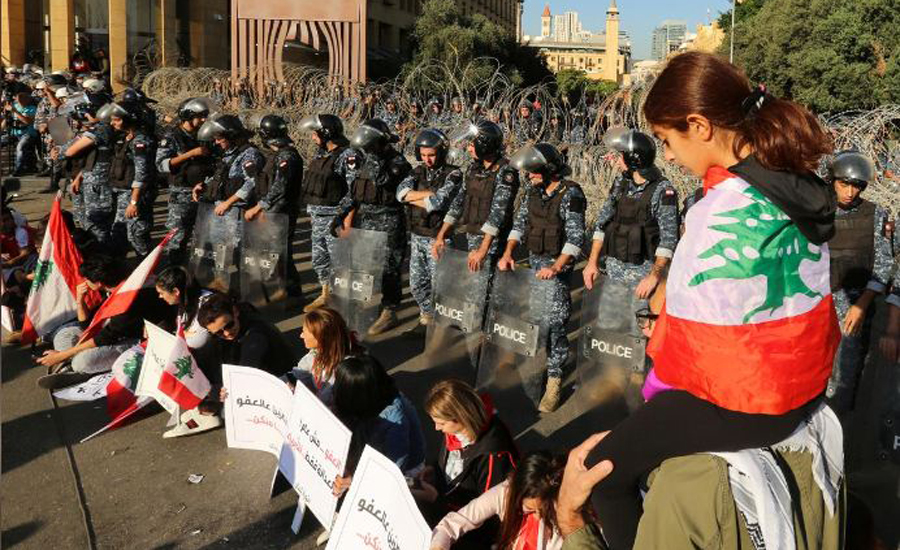 Protests force Lebanese parliament to postpone session, banks reopen