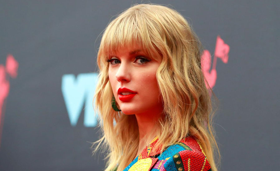 Death threats prompt music executive to appeal for peace in feud with Taylor Swift
