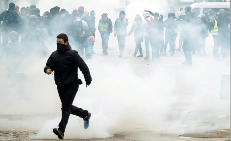 Paris police fire tear gas on 'yellow vest' protests anniversary
