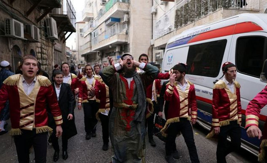 COVID curbs dampen carousing on Jewish costume festival Purim