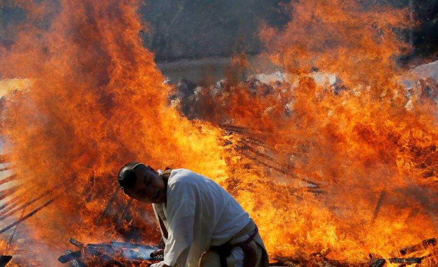 Japan worshippers brave smouldering coals to pray for safety