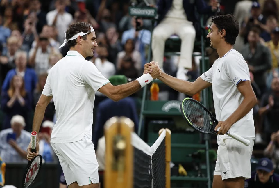 Golden oldie Federer weathers Sonego storm to reach quarters