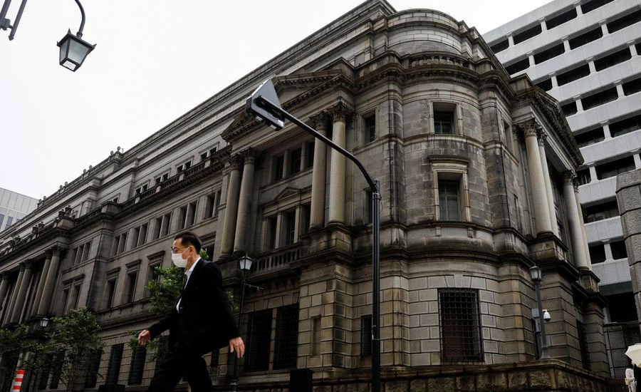 BOJ cuts growth forecast, unveils outline of climate scheme