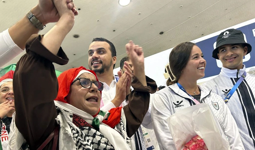 Palestinian Olympic team greeted with cheers and gifts in Paris